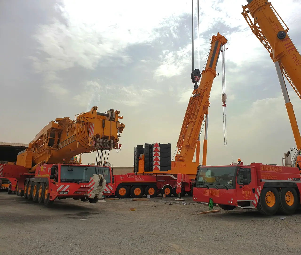 The FHS fleet of red and yellow all-terrain cranes in the yard